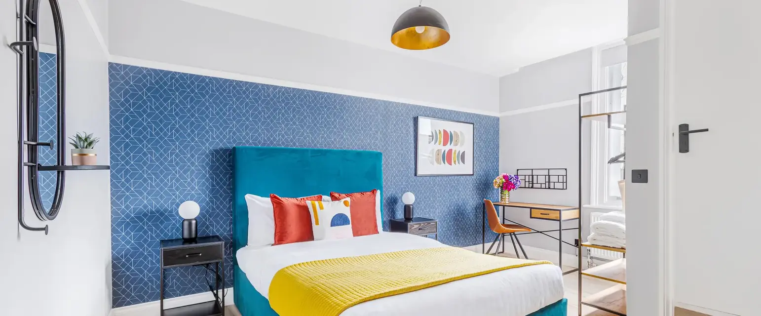 a bedroom with a blue and yellow bed