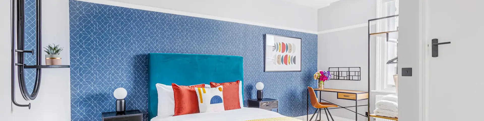 a bedroom with a blue and yellow bed