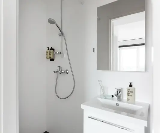 a bathroom with a shower and sink