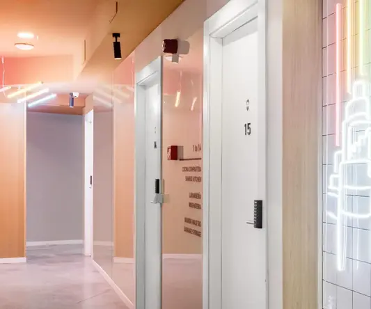 a hallway with white doors and a mirror