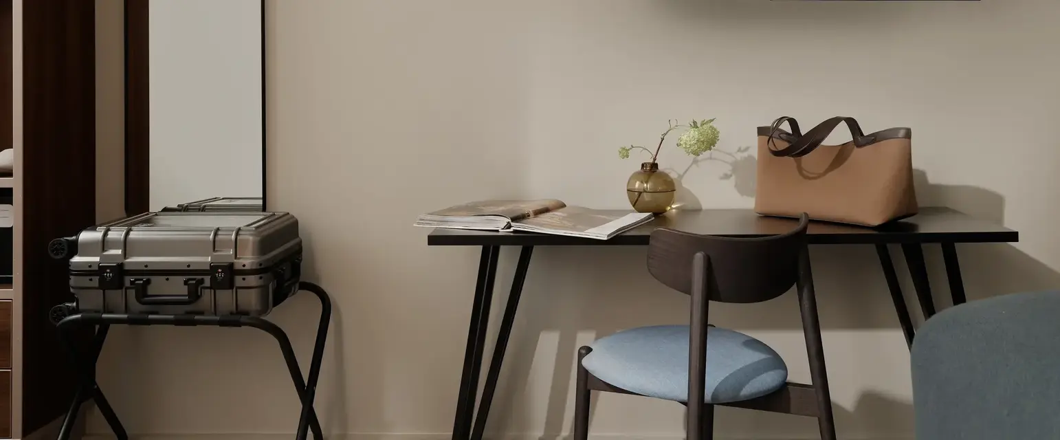a room with a table and a television on the wall